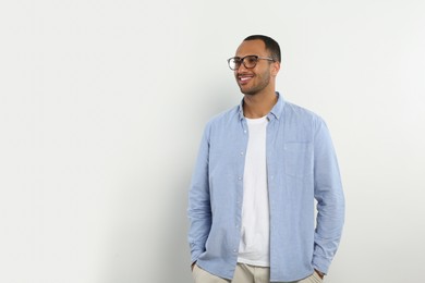 Portrait of handsome young man on white background, space for text