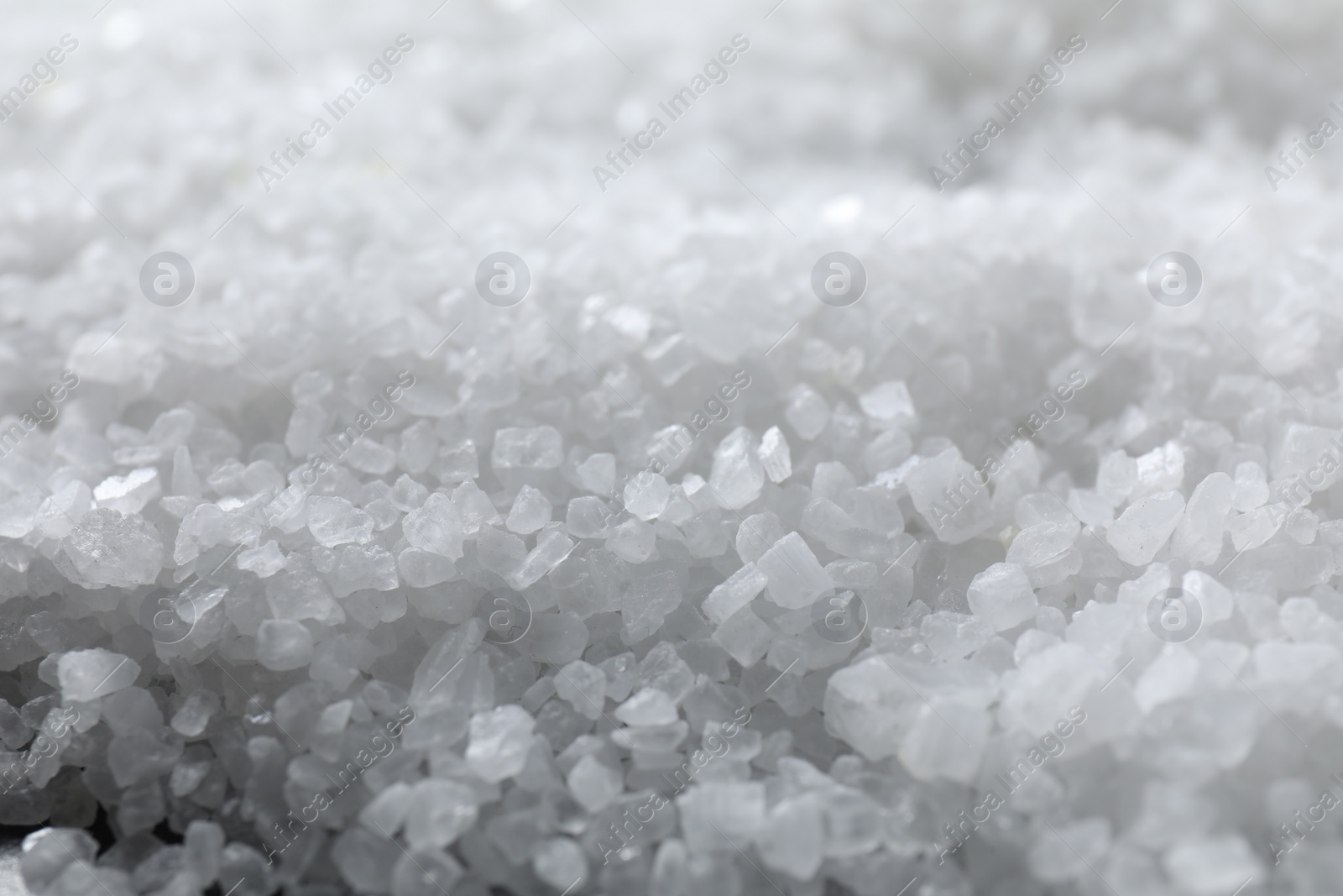 Photo of White natural salt as background, closeup view