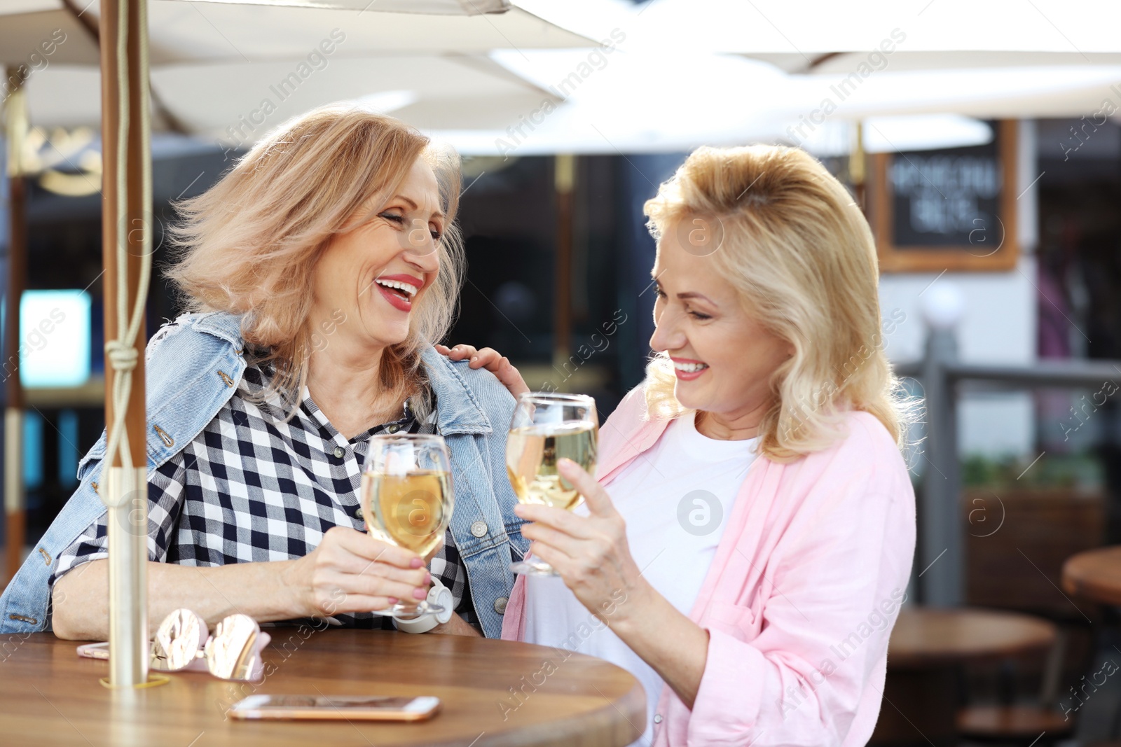 Photo of Mature women with drinks at outdoor cafe