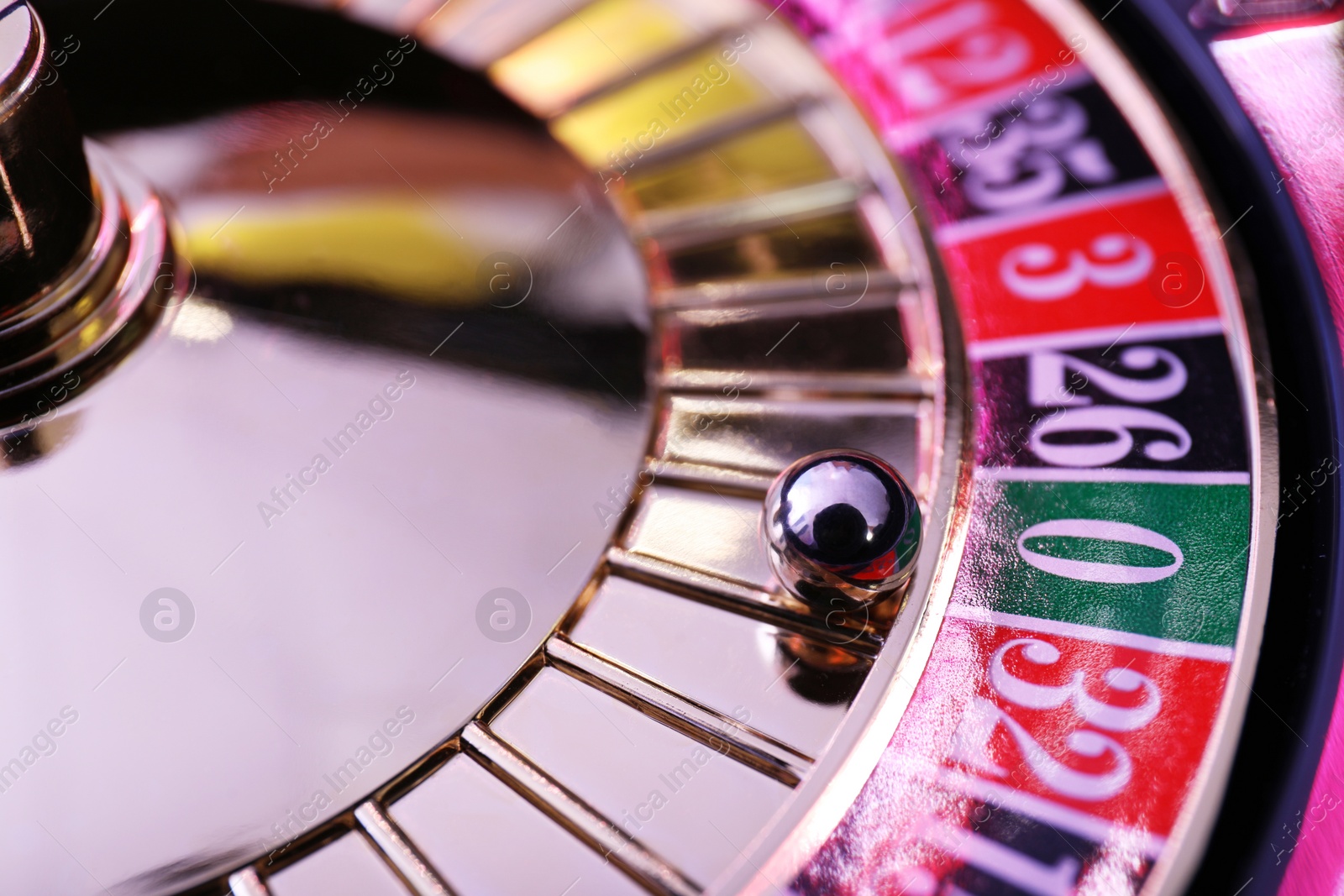 Photo of Roulette wheel with ball, closeup. Casino game