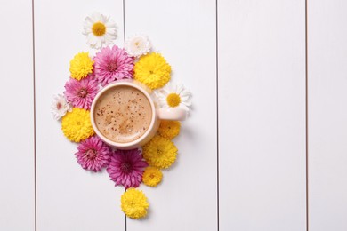 Photo of Beautiful floral composition with cup of hot coffee on white wooden background, flat lay. Space for text