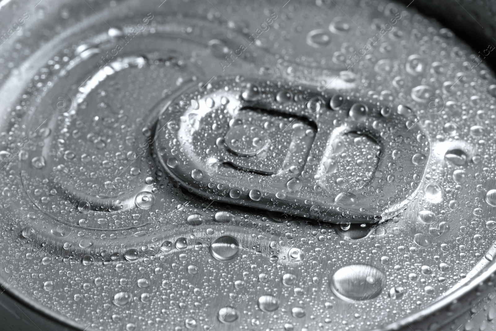 Photo of Aluminum can of beverage covered with water drops as background, closeup