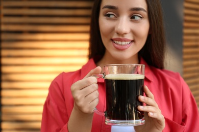 Photo of Beautiful woman with cold kvass outdoors. Traditional Russian summer drink