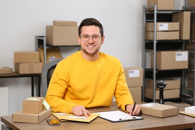 Seller with parcels working in office. Online store