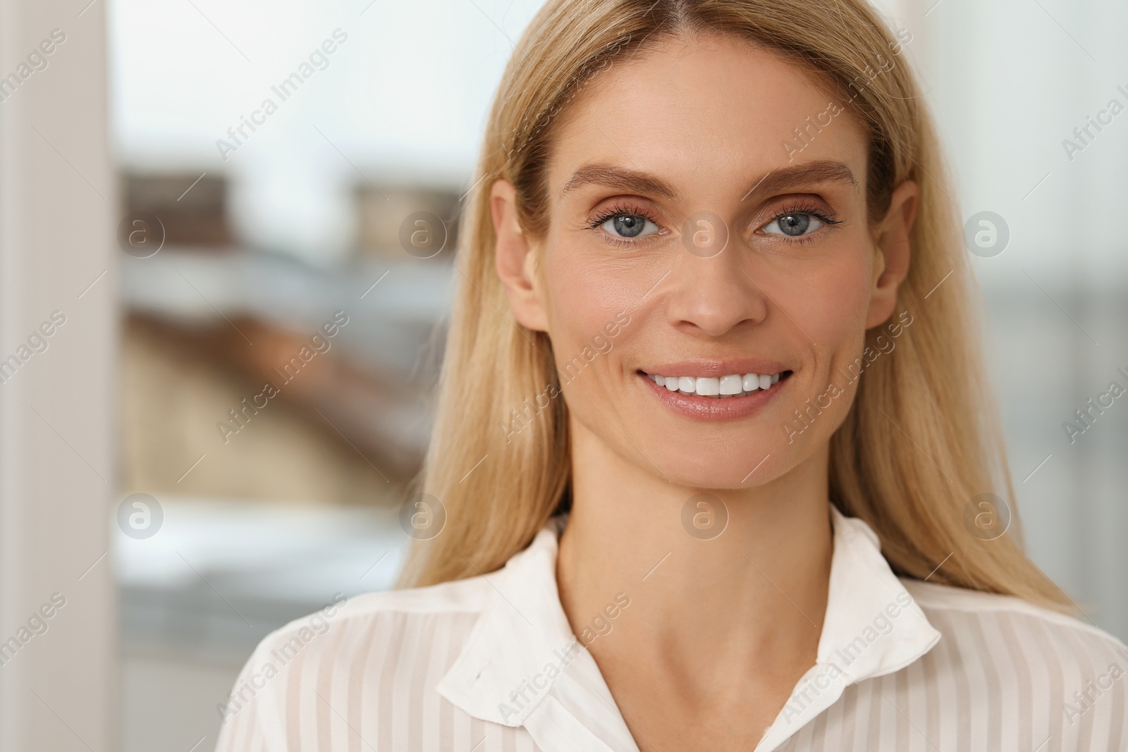 Photo of Portrait of confident entrepreneur or businesswoman, space for text. Beautiful lady with blonde hair smiling and looking into camera