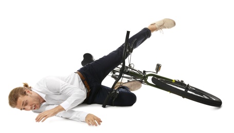 Photo of Young man falling off bicycle on white background