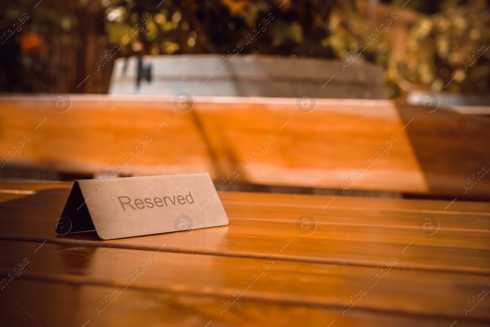 Photo of Sign Reserved on wooden table in restaurant. Space for text