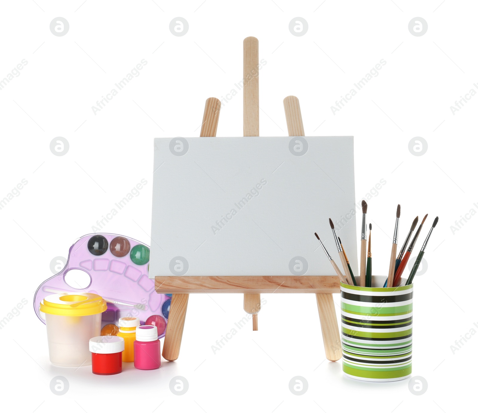 Photo of Wooden easel with blank canvas board and painting tools for children on white background