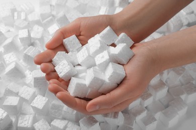 Photo of Woman with styrofoam cubes, closeup of hands