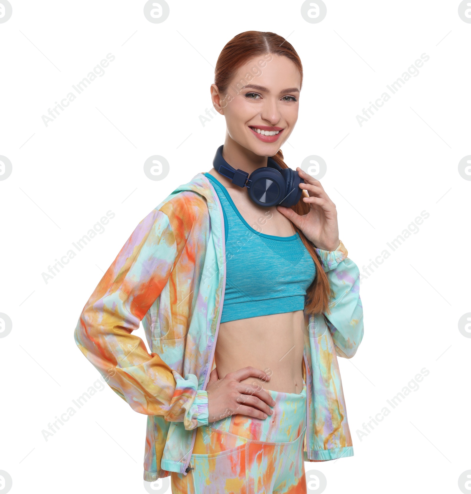 Photo of Young woman in sportswear and headphones on white background