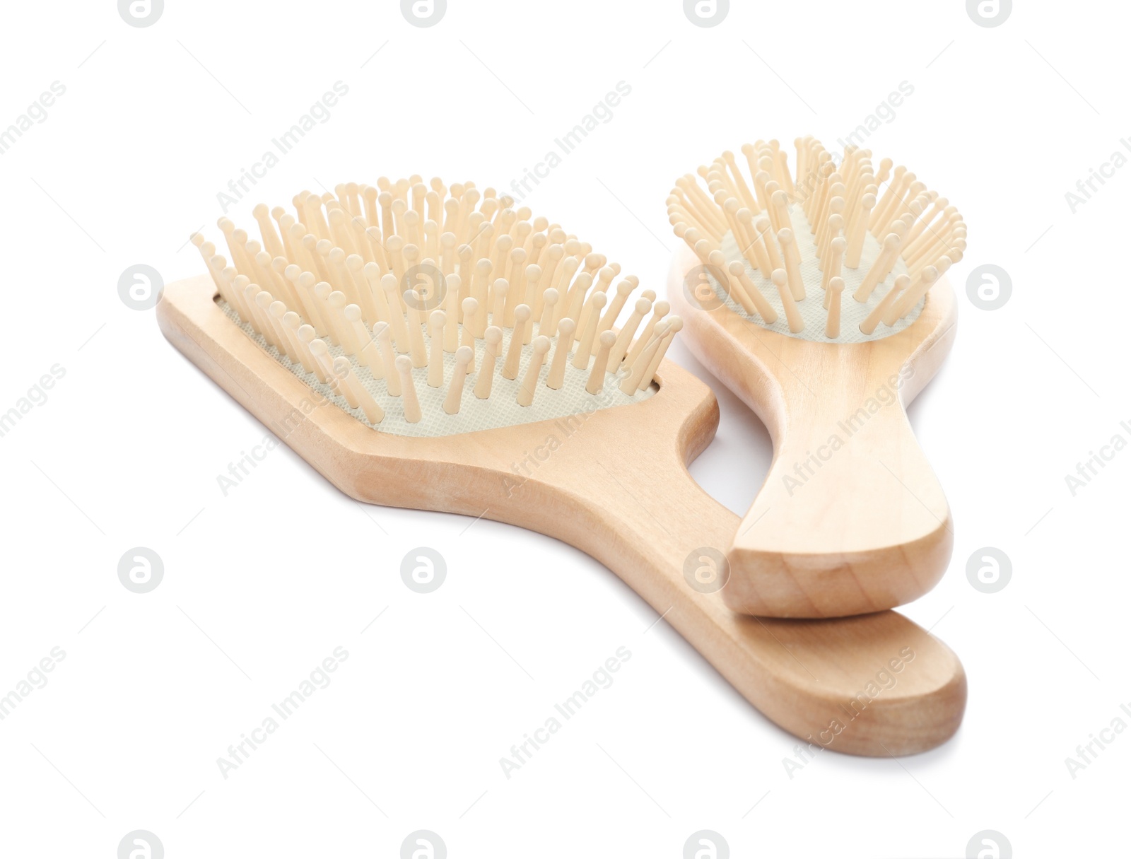 Photo of New wooden hair brushes on white background