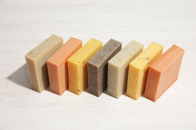Hand made soap bars on white wooden background