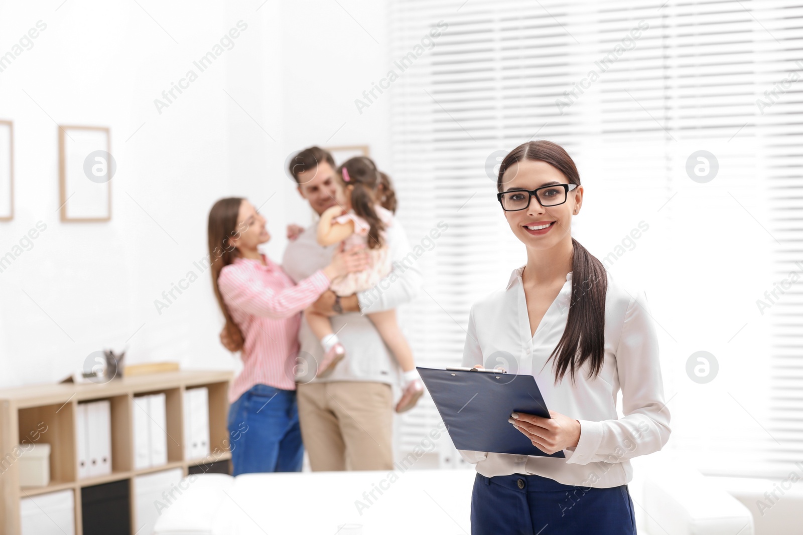 Photo of Professional psychologist and happy family in office