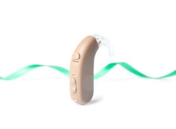 Hearing aid and ribbon on white background