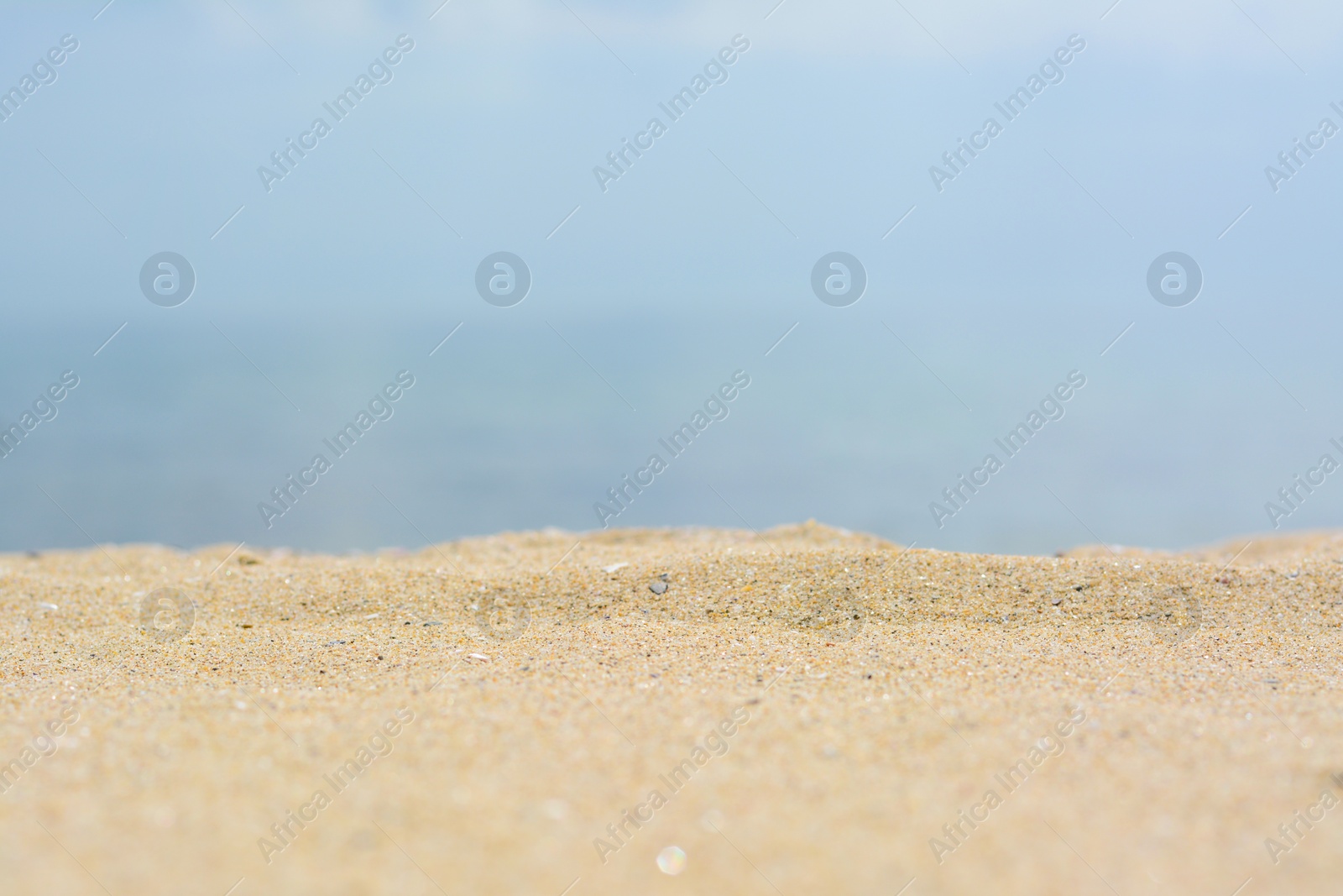 Photo of Beautiful beach with golden sand near sea, closeup view.