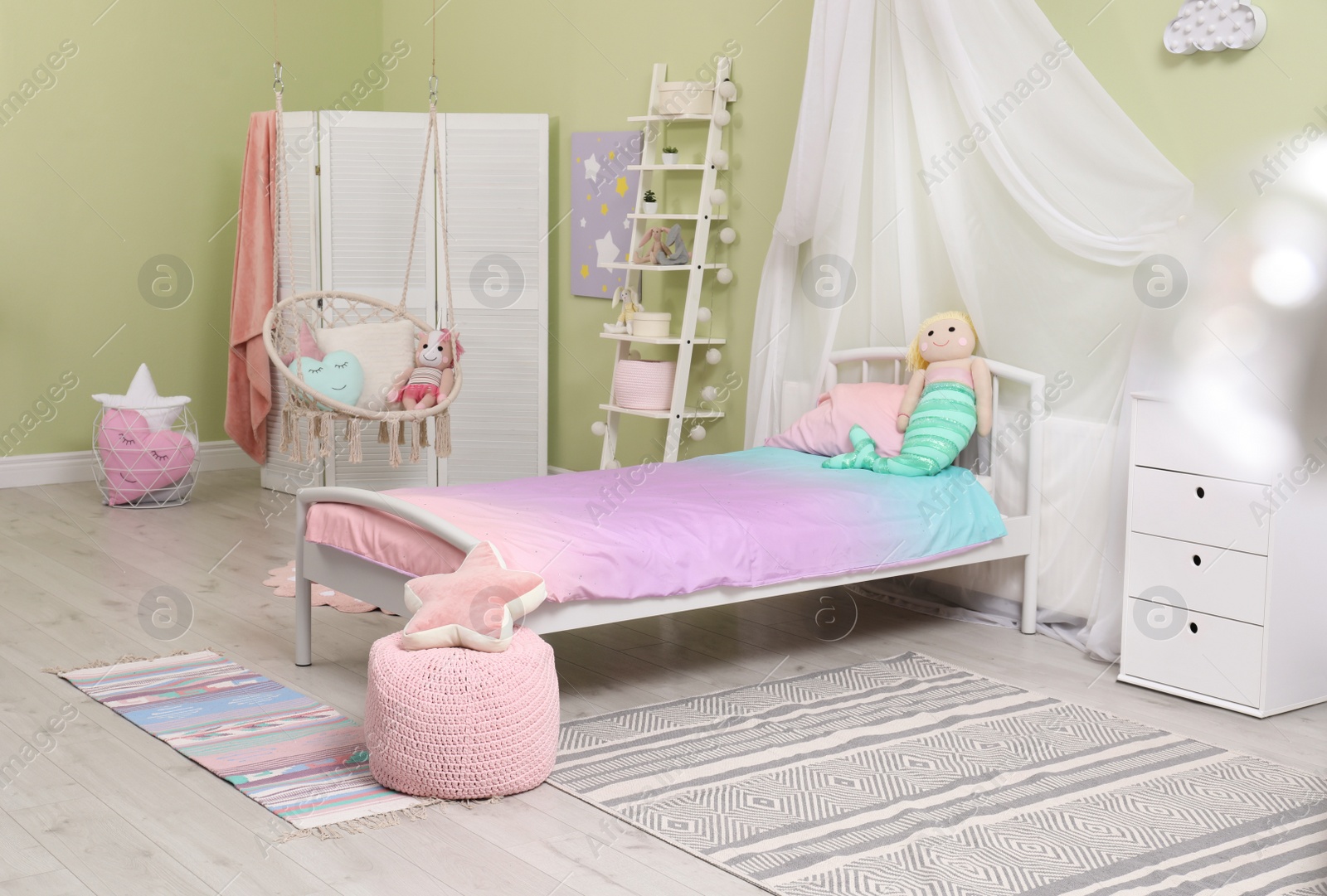 Photo of Cute child's room interior with toys and modern furniture