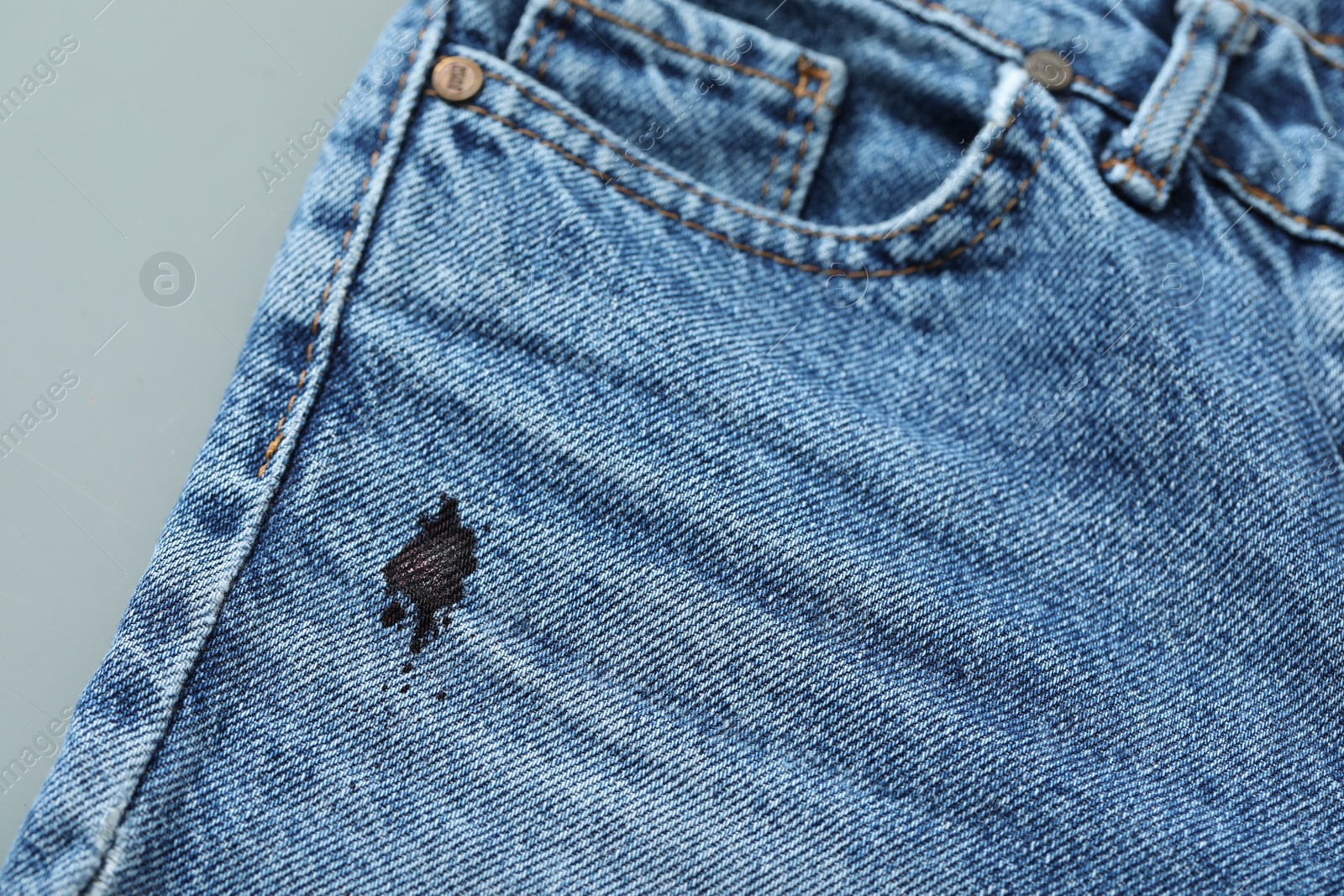 Photo of Stain of black ink on jeans, closeup. Space for text