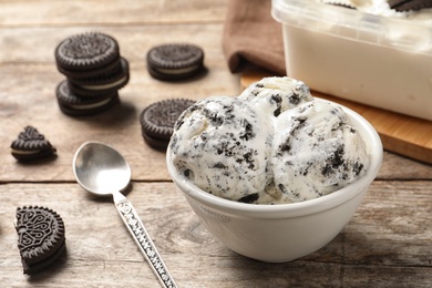 Bowl of chocolate cookies ice cream on table. Space for text