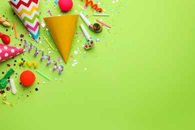 Photo of Beautiful flat lay composition with festive items on light green background, space for text. Surprise party concept
