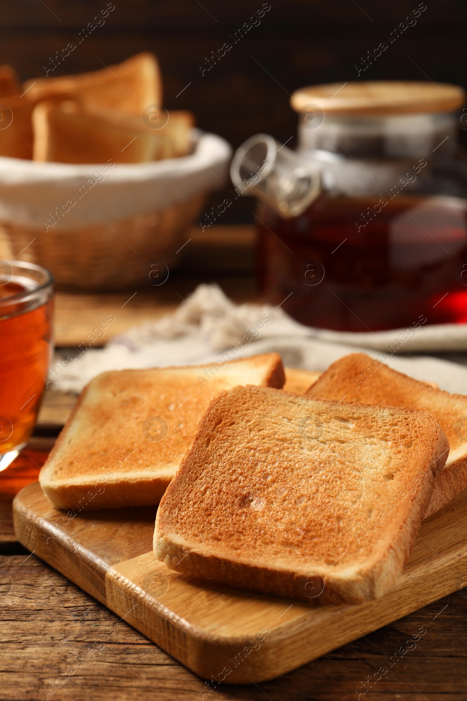 Photo of Slices of tasty toasted bread on wooden table