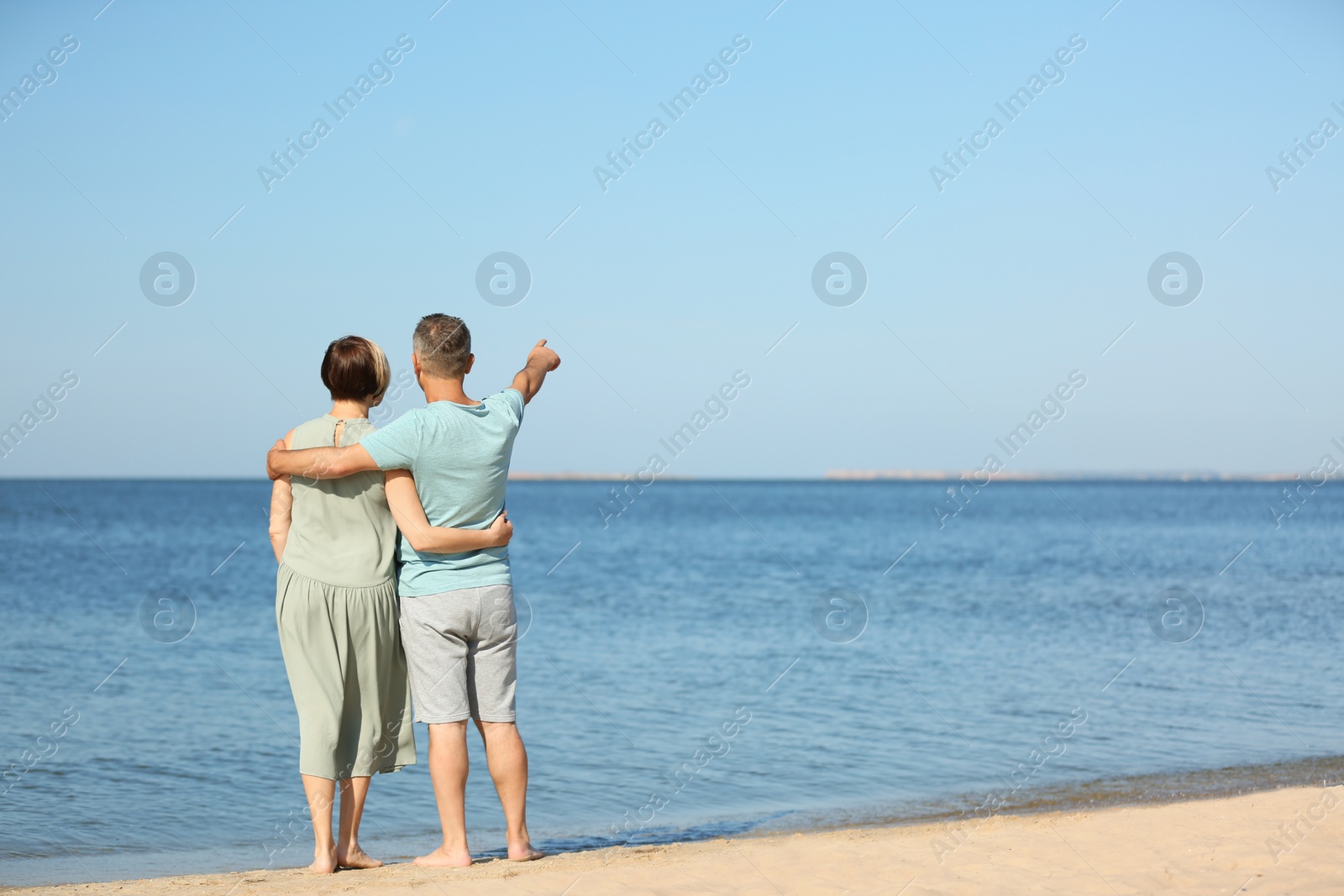 Photo of Happy mature couple at beach on sunny day