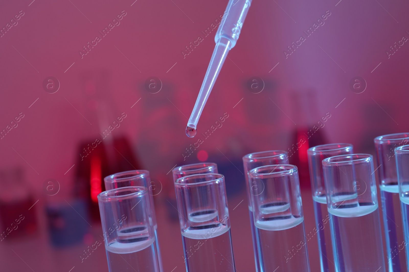 Photo of Dripping reagent into test tube, closeup. Laboratory analysis