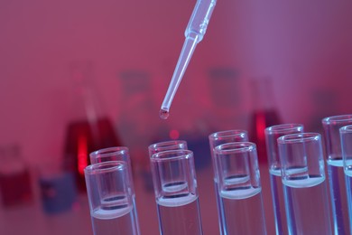 Photo of Dripping reagent into test tube, closeup. Laboratory analysis