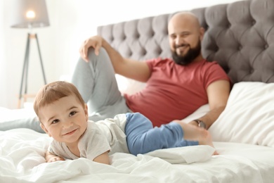 Photo of Dad and his little son spending time together at home