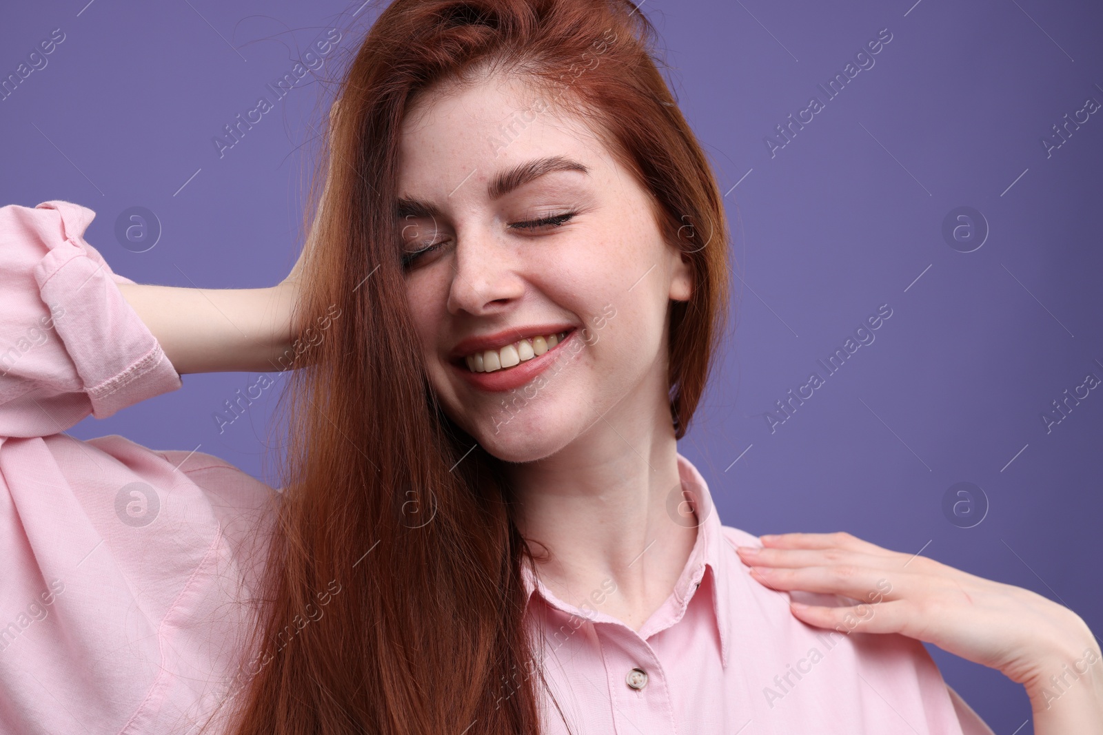 Photo of Portrait of smiling woman with freckles on purple background