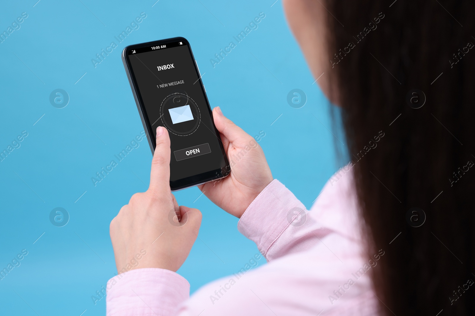 Image of Got new message. Woman using smartphone on light blue background, closeup
