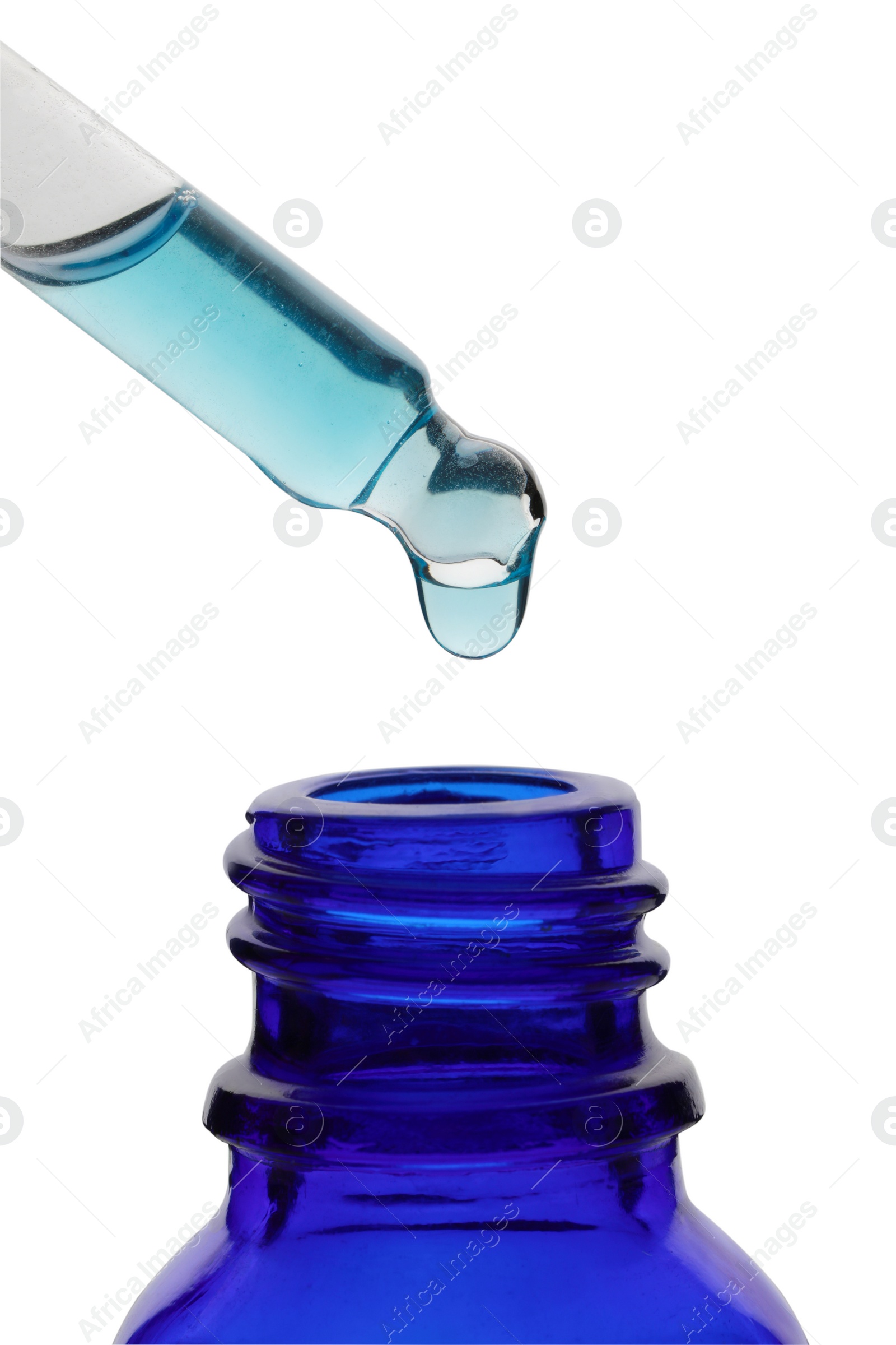 Photo of Dripping light blue facial serum from pipette into glass bottle on white background, closeup