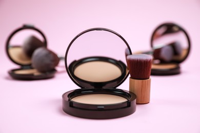 Photo of Face powder and brush on pink background. Decorative cosmetic