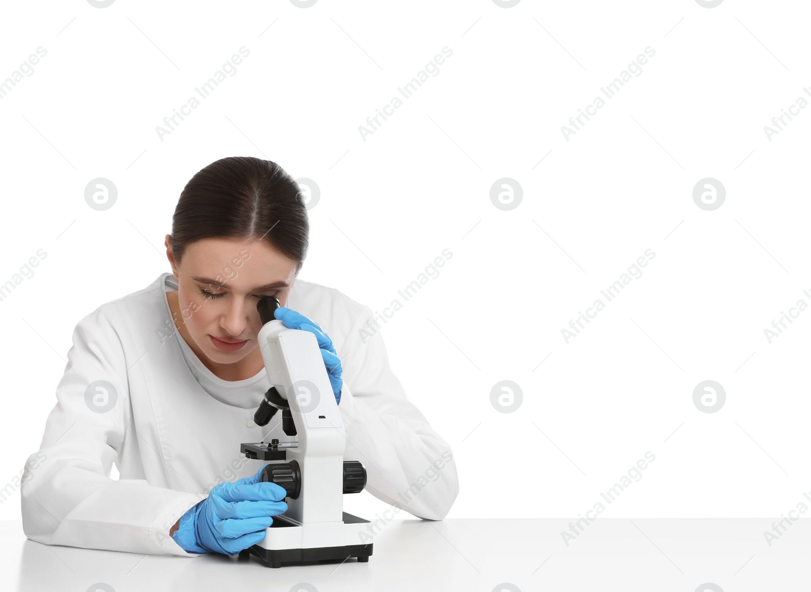 Photo of Scientist using modern microscope at table isolated on white. Medical research