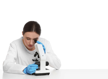 Scientist using modern microscope at table isolated on white. Medical research