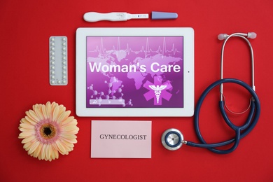 Flat lay composition with tablet, stethoscope, birth control pills and pregnancy test on color background. Gynecological care