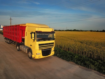 Photo of Modern truck on country road. Space for text