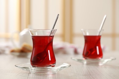 Photo of Glasses of traditional Turkish tea on white wooden table indoors. Space for text