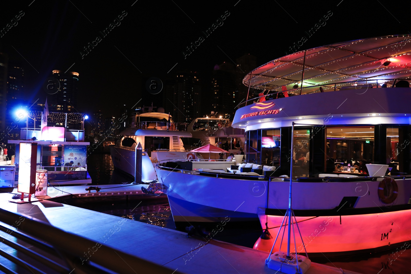 Photo of DUBAI, UNITED ARAB EMIRATES - NOVEMBER 03, 2018: Pier with luxury yachts at night