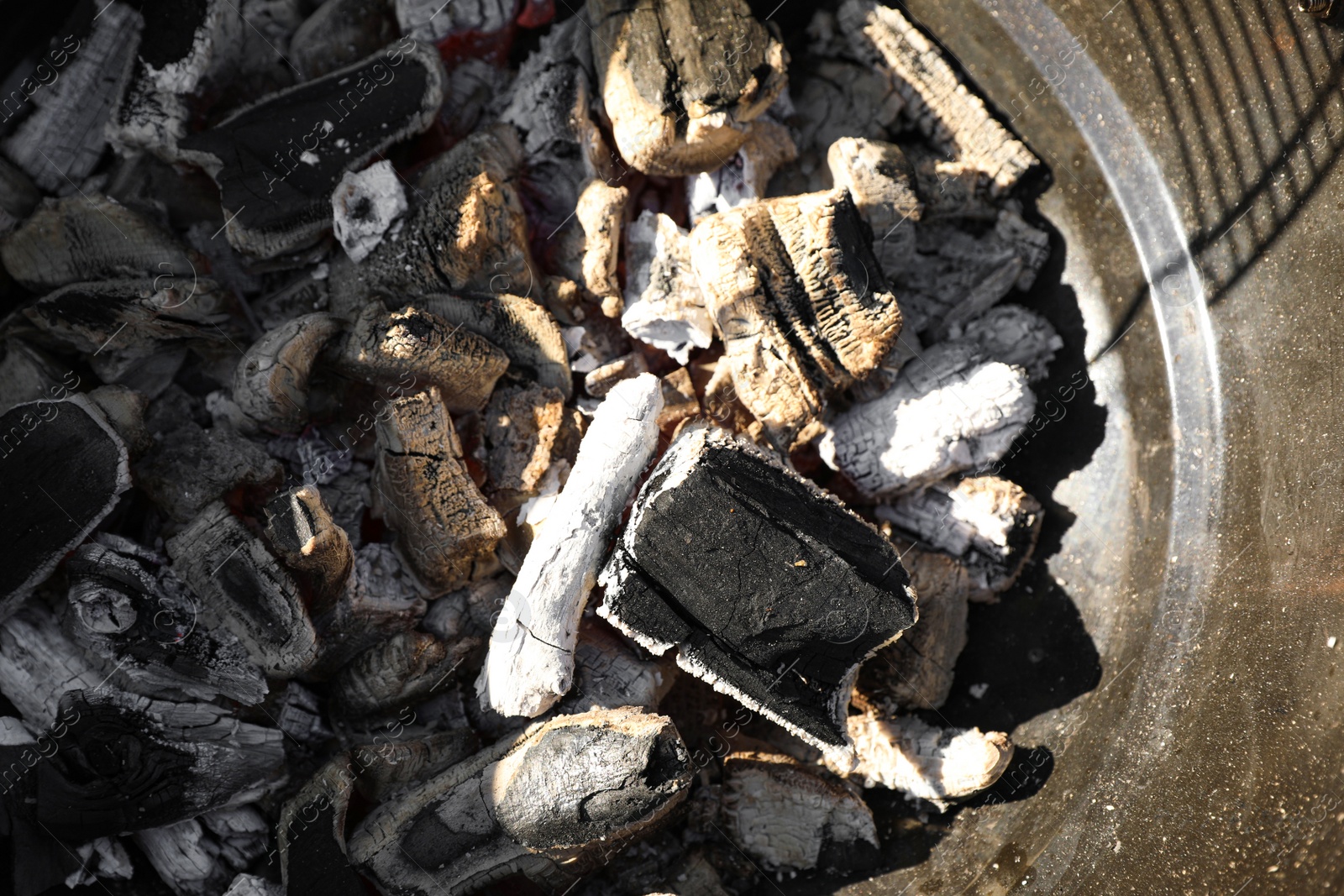 Photo of Barbecue grill with coals outdoors, top view