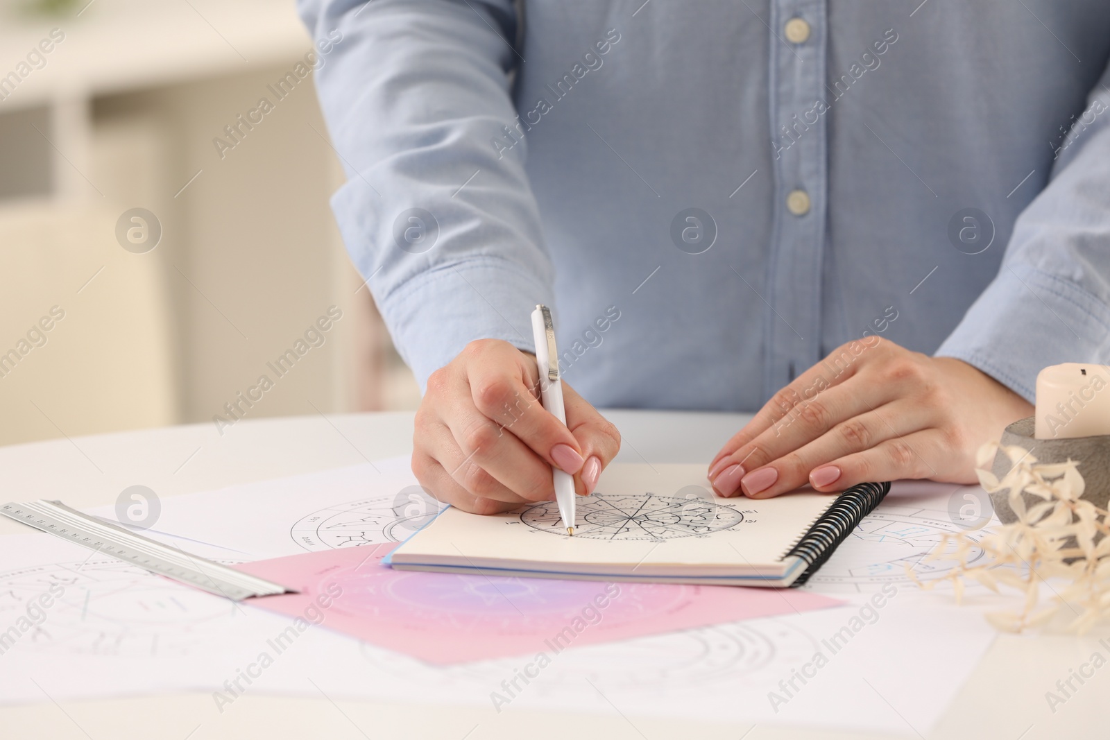 Photo of Astrologer using zodiac wheel for fate forecast at table, closeup and space for text. Fortune telling