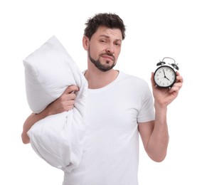 Photo of Tired man with alarm clock and pillow on white background. Insomnia problem