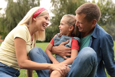 Photo of Happy family spending time together in park on sunny summer day