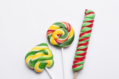 Sweet lollipops on light background, flat lay