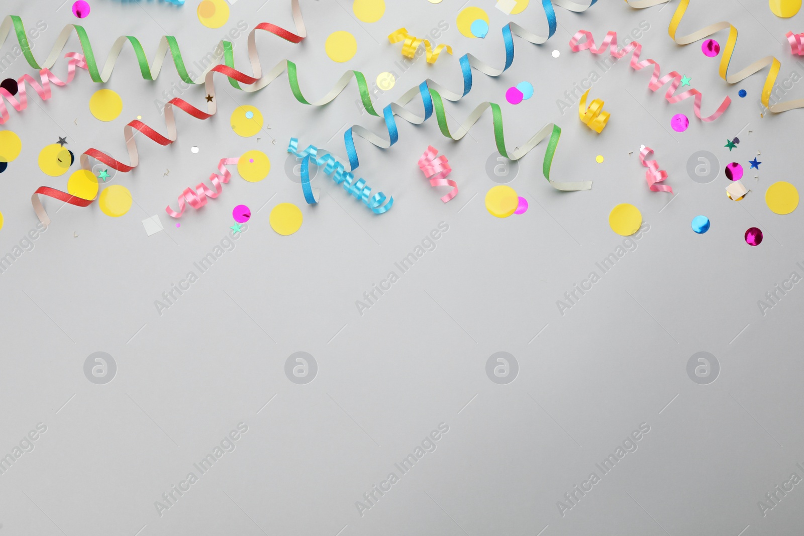 Photo of Flat lay composition with carnival items on light grey background. Space for text