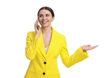 Photo of Beautiful businesswoman in yellow suit talking on smartphone against white background