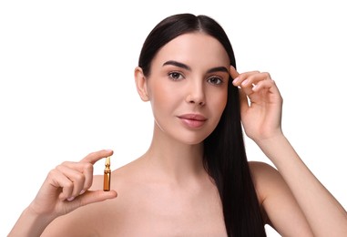 Beautiful young woman holding skincare ampoule on white background