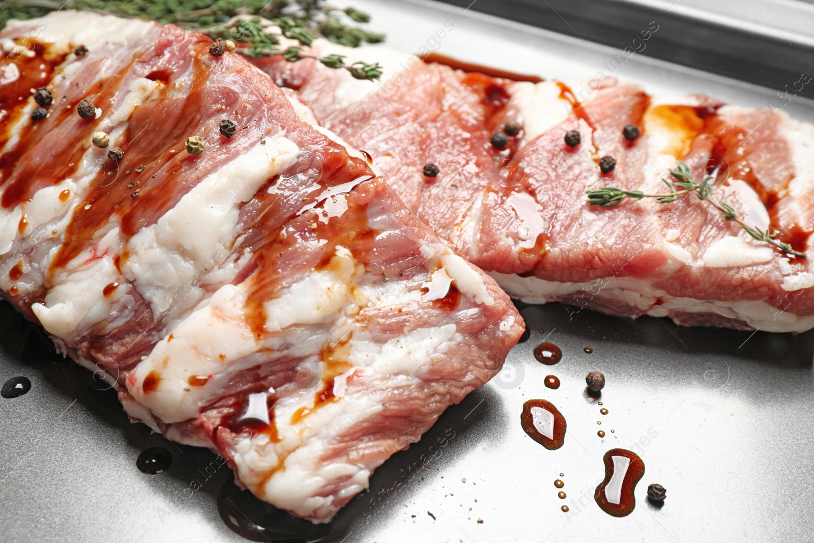 Photo of Fresh raw ribs on baking sheet, closeup