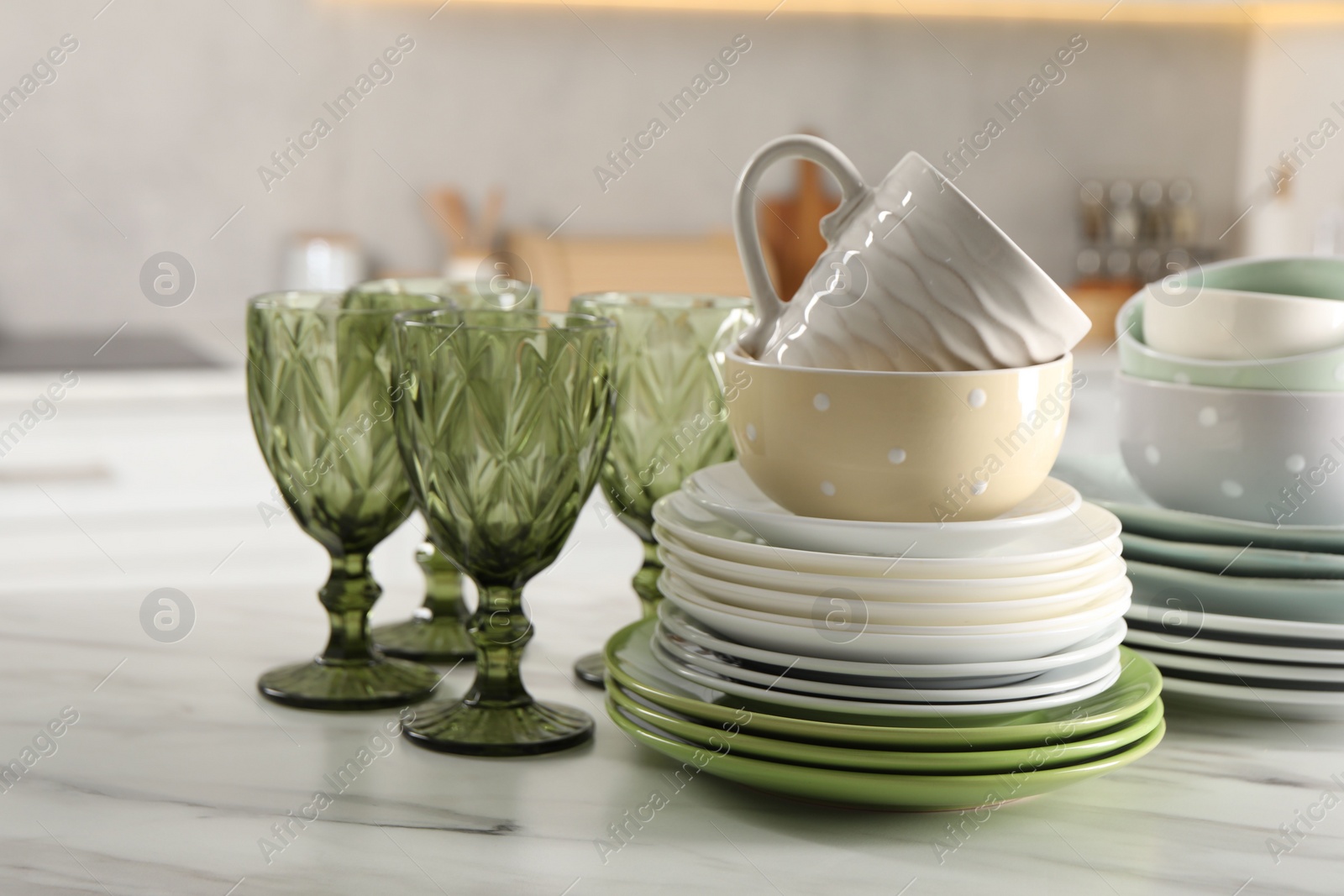 Photo of Many different clean dishware, glasses and cup on white marble table indoors