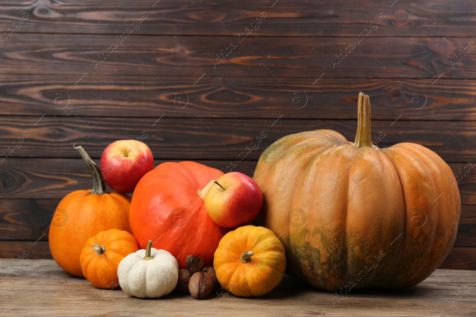 Photo of Happy Thanksgiving day. Beautiful composition with pumpkins on wooden table