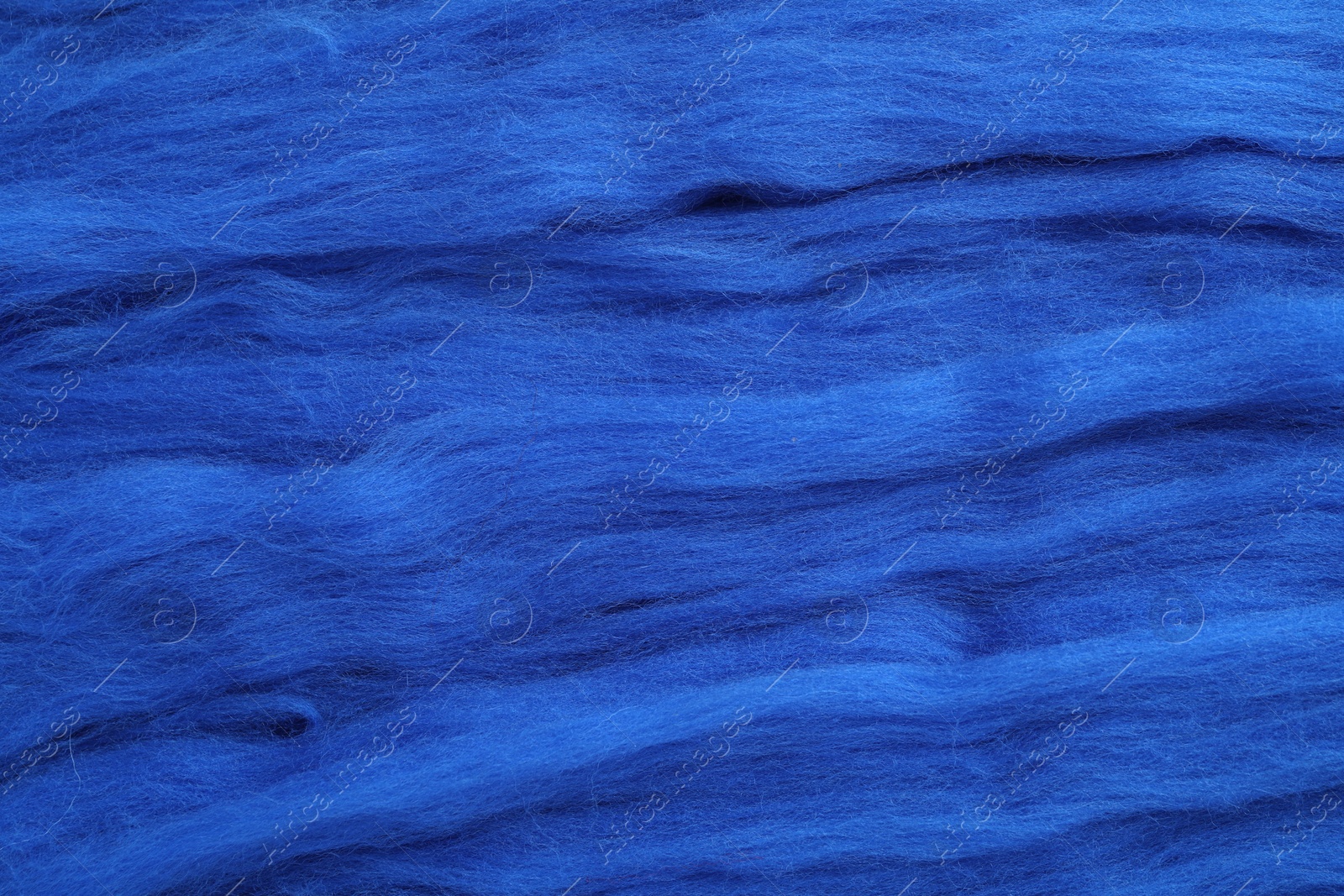 Photo of Blue felting wool as background, closeup view